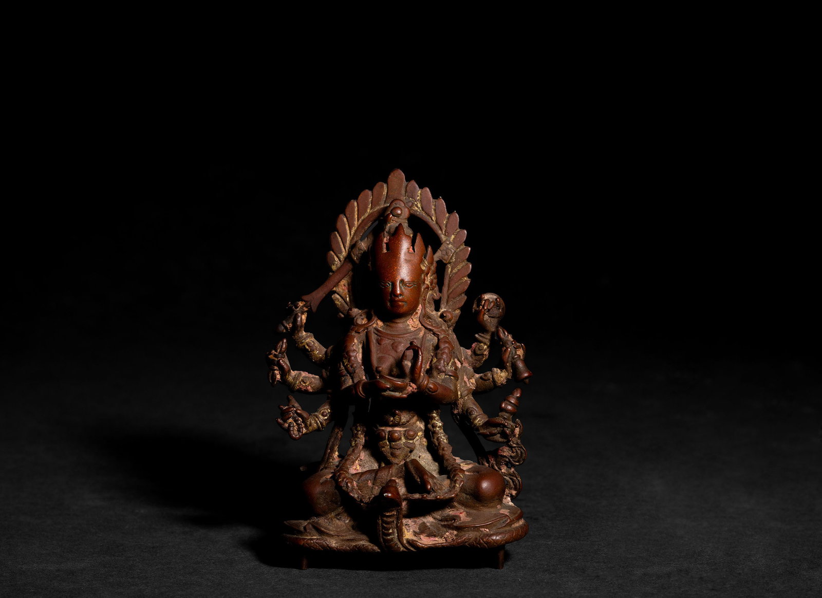 Exceptional Gilt Bronze Figure of Vasudhara, 16th Century: Exceptional 16th century gilt bronze figure of Vasudhara, the goddess of abundance, seated in a meditative pose before a leaf shaped mandorla. The multi armed deity is finely cast with a serene face,