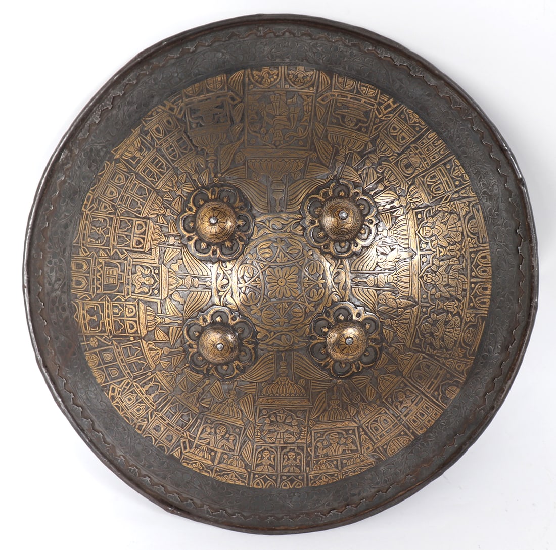 Fantastic Gold Inlaid Indo-Persian Dhal Shield: Indo-Persian Steel Dhal shield with fantastic gold wire inlaid surface details of royal court figures and temples. The border with a carved interior lip in the form of temples and an engraved border