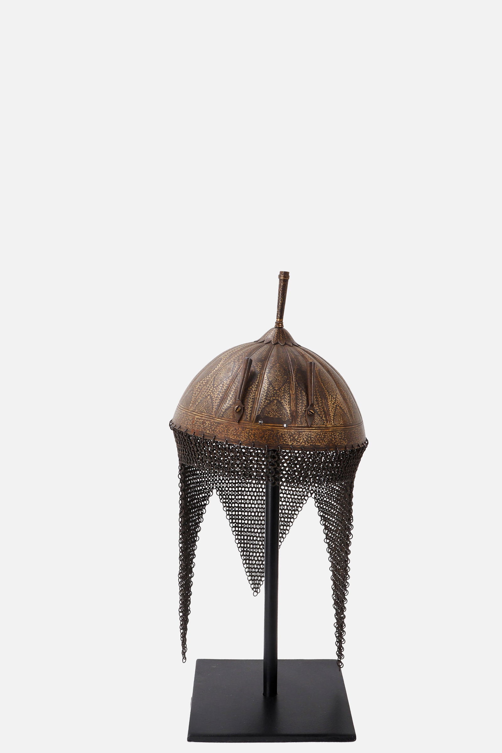 A Fine Indian Gold Koftgari Helmet with Mail Aventail, North India 18th - 19th C.: Probably Northern India, 18th-19th century. The domed steel skull rising to a slender finial above a foliate base. The surface richly decorated throughout with dense scrolling vegetal ornament