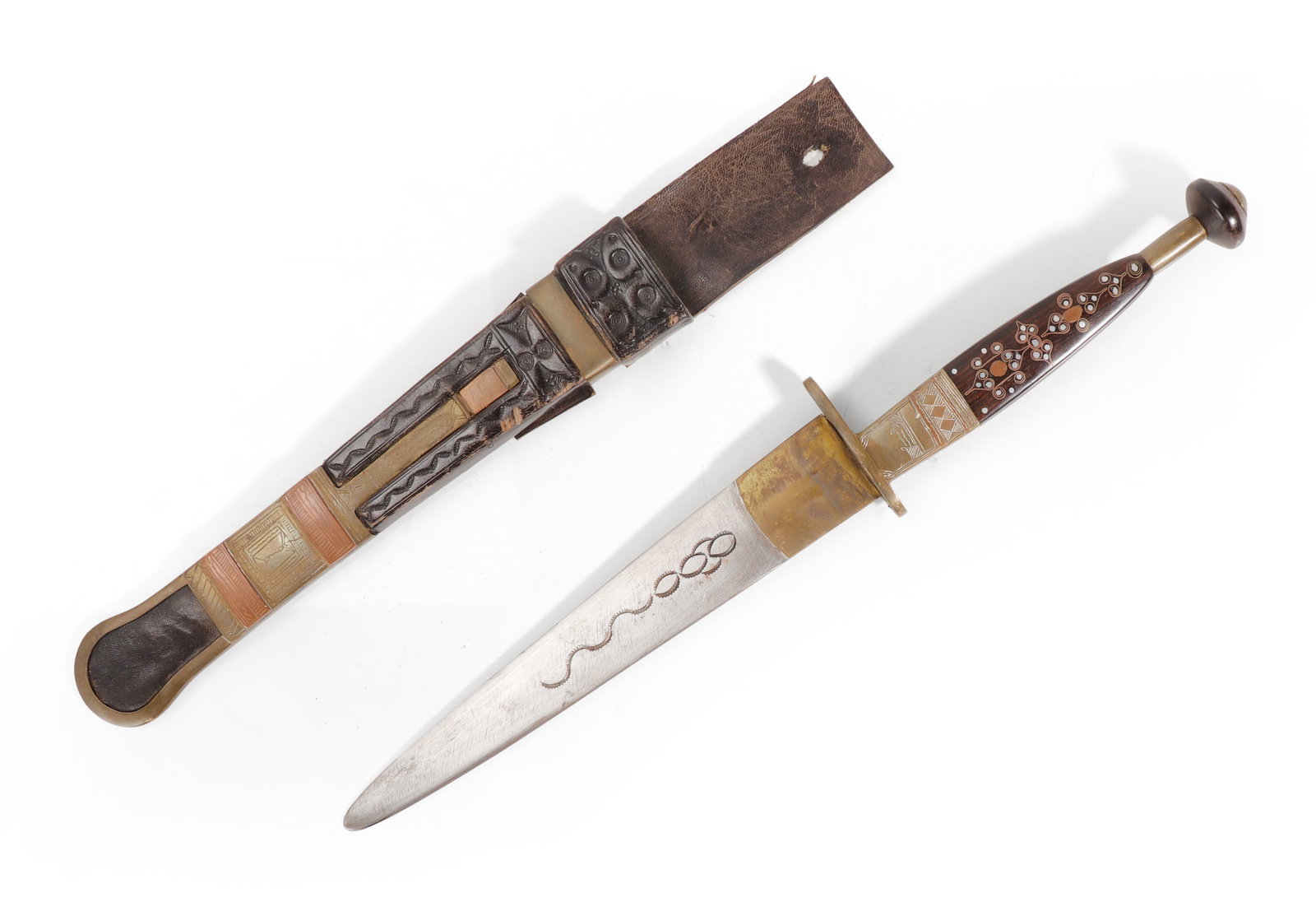 West African Decorative Dagger, 20th C.: Probably Mali, West Africa, 20th century. Decorative dagger with a single edged blade housed in an ornate scabbard. The hilt and scabbard are decorated with geometric motifs and circular inlays, with