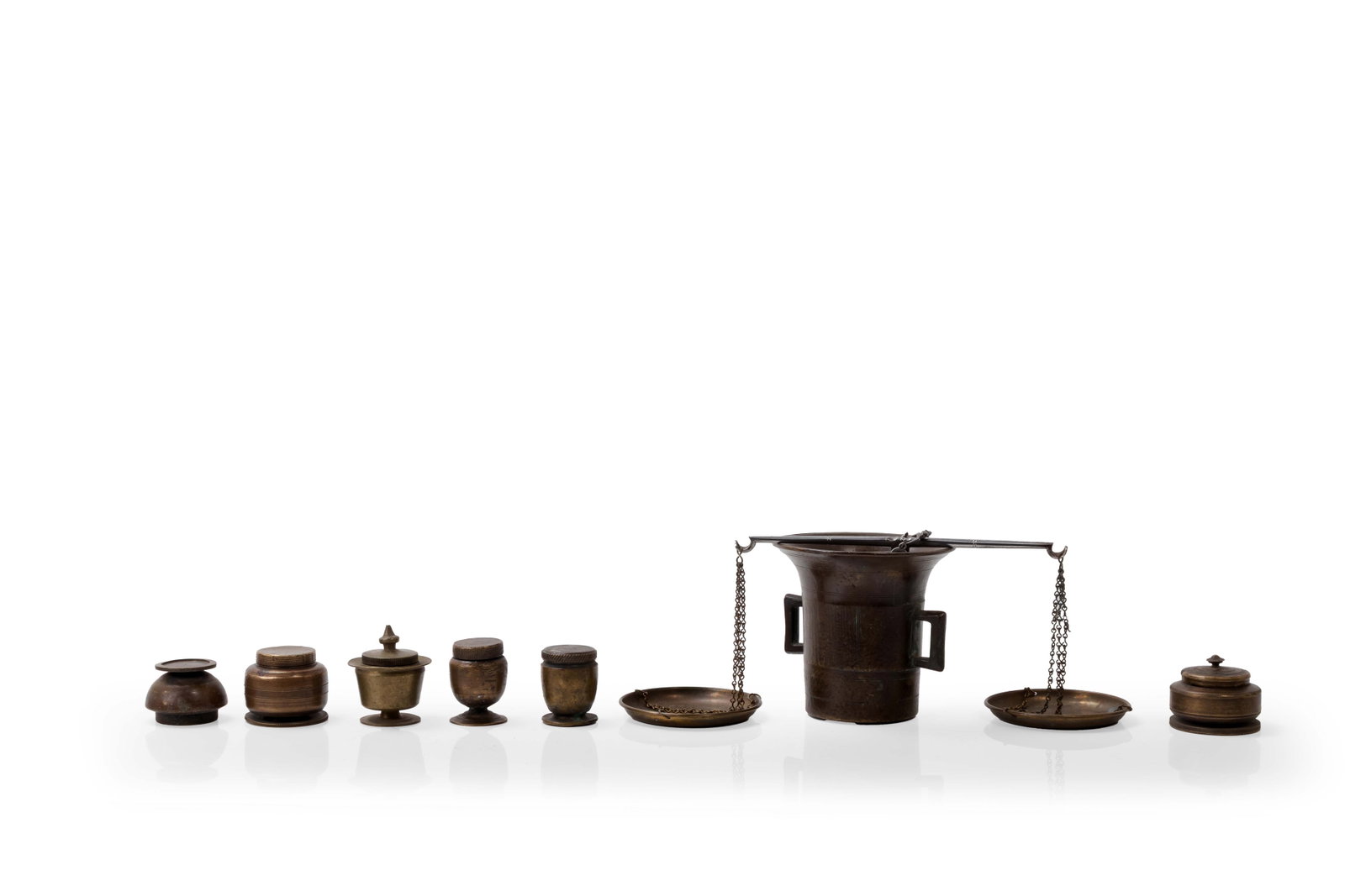 Brass Apothecary and Powder Measure Set, 19th Century: Nine piece brass or bronze measuring set, English or American, 19th century. The group includes six small lidded graduated containers, several with screw lids and marked measurement inscriptions,