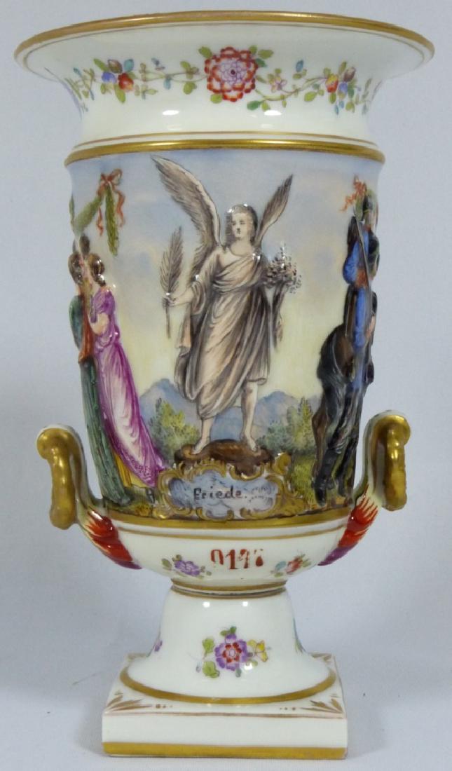 CAPODIMONTE PORCELAIN URN: Capodimonte porcelain urn decorated with scene of soldiers returning to their families, Marked to Bottom with a Crowned N. Measures 5 1/2" (14cm) height.