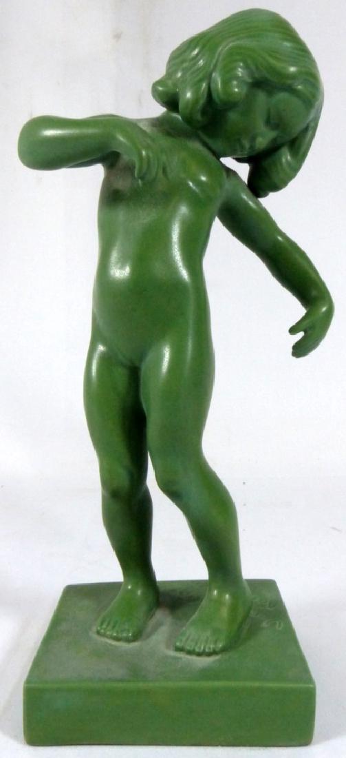 KAI NIELSEN 'VENUS KALIPYGOS' DANISH POTTERY NUDE: Kai Nielsen green glazed pottery figurine of a nude girl. Made by made by Ipsen Enke Copenhagen. Marked to bottom and numbered 888. Measures 8 1/4" (21cm) height.