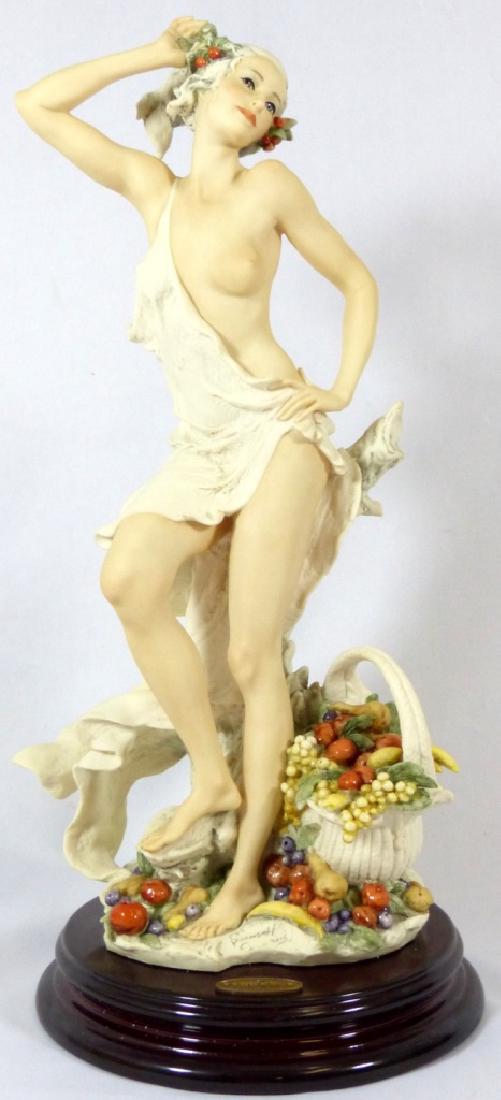 GIUSEPPE ARMANI 'POMONA' PORCELAIN FIGURINE w BOX: Giuseppe Armani 'Pomona' porcelain figure #0174-F with original box. Depicts a nude woman with a basket of fruit. Signed to front and Capodimonte crown mark to back of porcelain base. Plaque attached