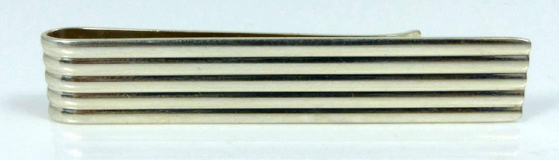 TIFFANY & CO STERLING SILVER FLUTED MONEY CLIP: Tiffany & Co vintage sterling silver fluted money clip. Marked to reverse Tiffany & Co, Sterling. Measures 5.3cm. Total weight 7.1g.