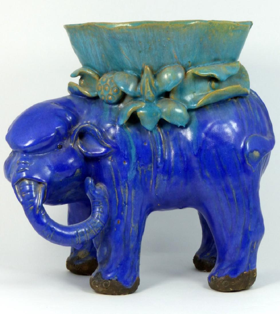 BLUE GLAZED EARTHENWARE ELEPHANT PLANTER: Blue glazed earthenware elephant planter. Measures 10" (25.5cm) length and height.