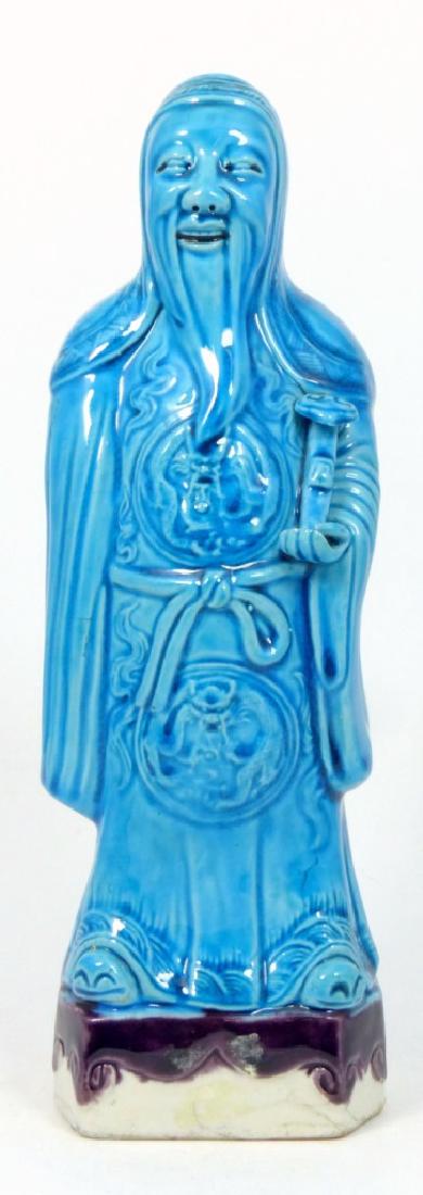 CHINESE TURQUOISE GLAZED IMMORTAL FIGURINE: Chinese turquoise glazed porcelain figurine of an immortal with scepter in hand. Measures 10" (25.5cm) height.