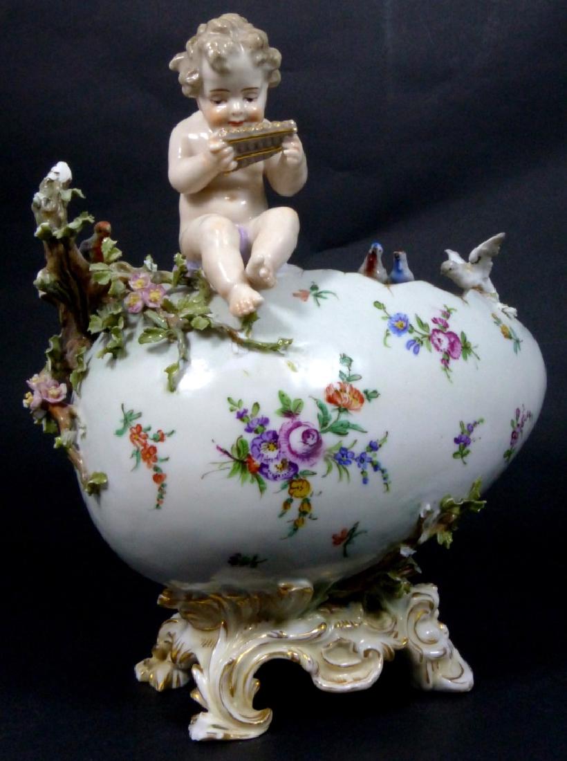GERMAN PORCELAIN FIGURAL EGG-FORM VASE: German porcelain vase in the form of an egg with seated cherub and several perched birds. Impressed shield mark to underside, possibly Nymphenburg, and impressed 2801. Measures 9 1/4" (23.5cm) height.