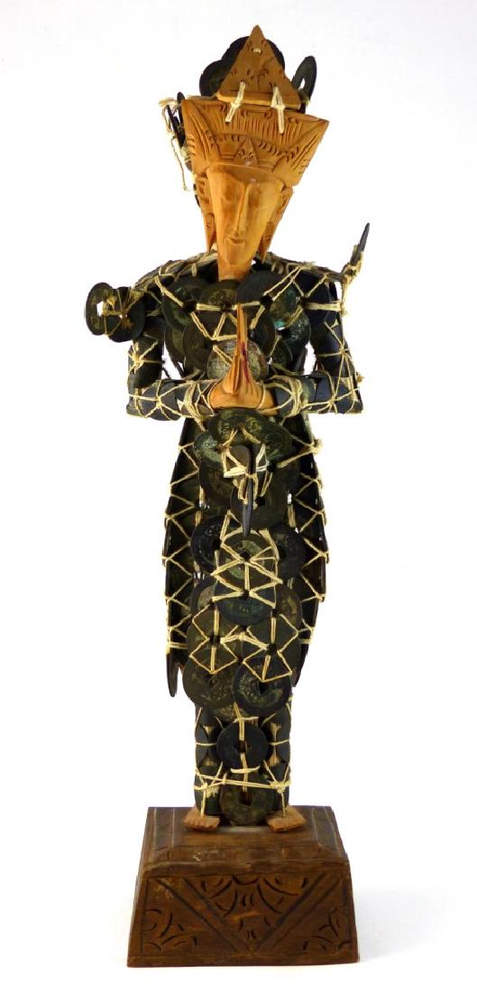 CHINESE CEREMONIAL COIN FIGURE: Balinese buddha comprised of Chinese coins with carved face, hands and feet. Measures 13" (33cm) height + 1 1/2" (3.7cm) base.