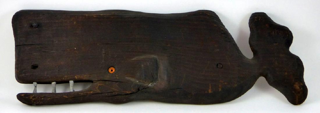 JARVIS BOONE FOLK ART WHALE WALL SCULPTURE: Jarvis Boone folk art wall sculpture in the form of a whale. Impress JB and holds original label to verso. Dated 1962. Measures 18 1/2" (47cm) length.
