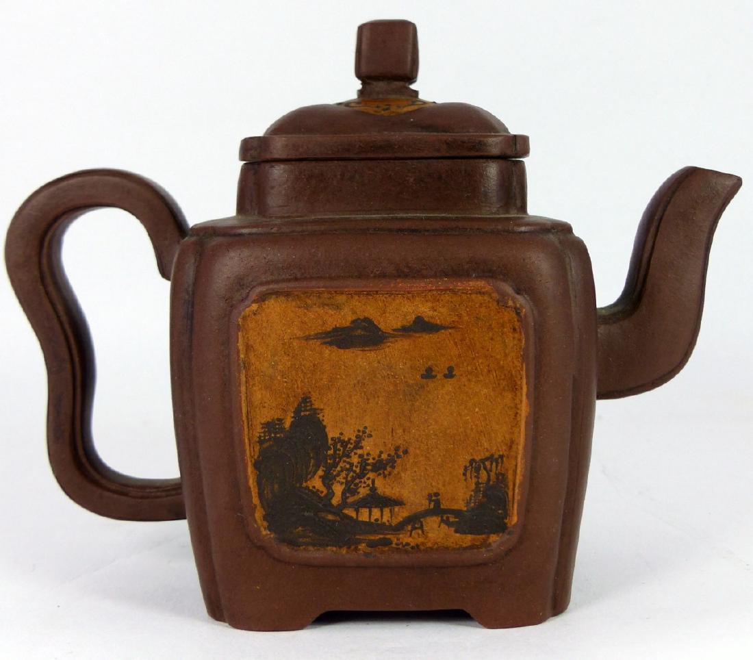 CHINESE YIXING TEAPOT w LANDSCAPE MOTIF: Chinese Yixing clay teapot of squared form having panels depicting landscape scenes to both sides. Marked to underside. Measures 6" (15.2cm) length.