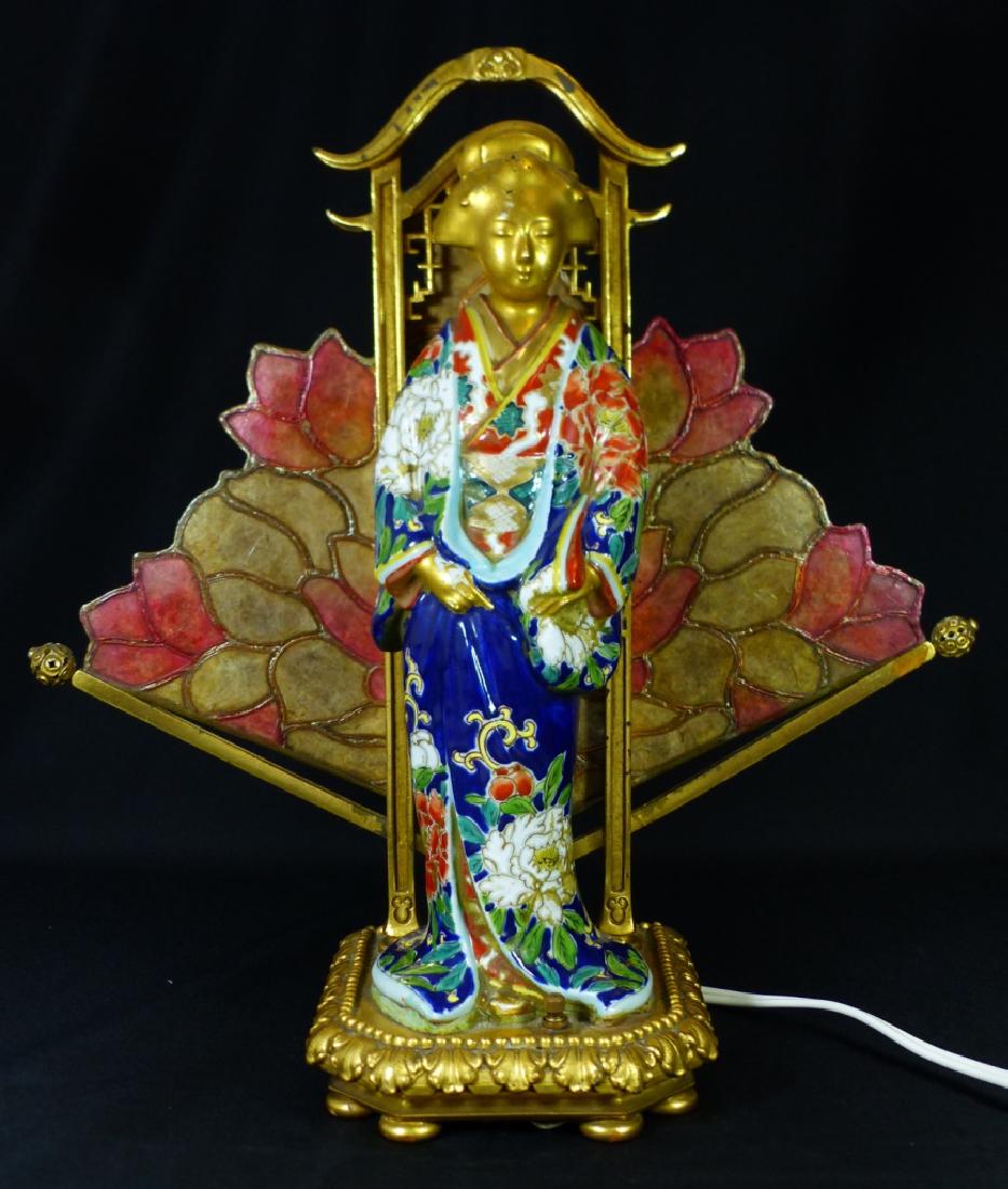 CHINESE PORCELAIN FIGURAL LAMP w LOTUS FLAME: Chinese porcelain figure of a maiden mounted as a lamp in front of flame decorated with lotus blossoms. Figure having gold gilt head and hands, wearing robe decorated with blossoms over a cobalt blue
