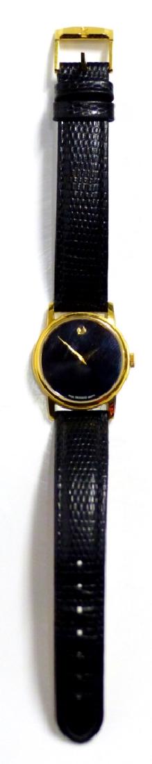 MOVADO GOLD TONE WRISTWATCH w LEATHER BAND: Movado gold plated stainless steel wrist watch with Quartz movement and leather band. Marked Movado to case and band. Case measures 27.5mm width excluding crown.