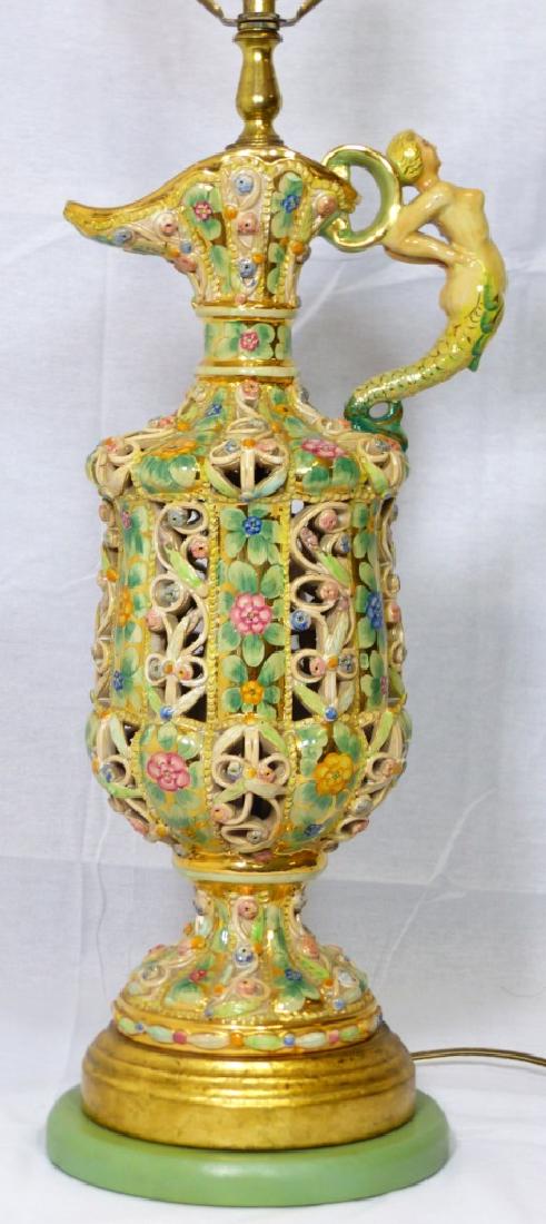 PIERCED PORCELAIN EWER/LAMP w NUDE MERMAID HANDLE: Porcelain ewer mounted as a lamp having gilt and floral reticuled decoration and handle in the form of a nude mermaid. No apparent markings. Probably Capodimonte. Porcelain pitcher measures 15 1/2" (3