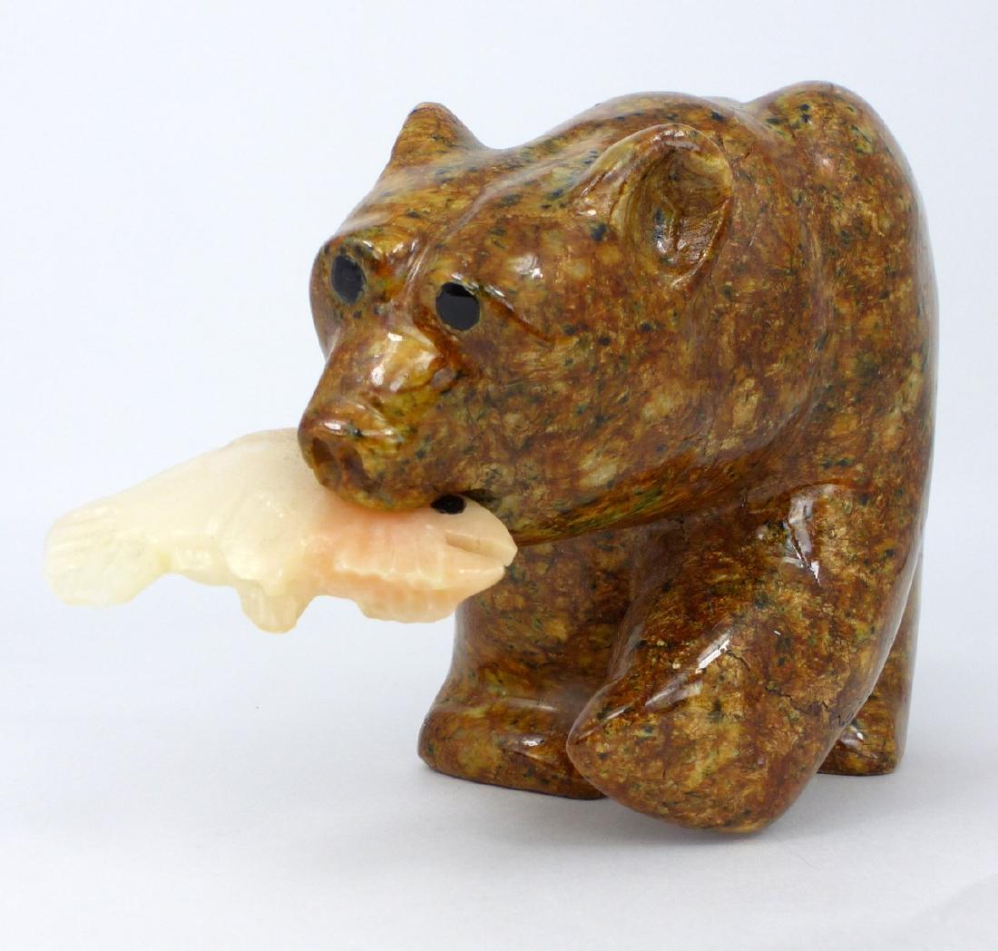 JON PUST INUIT STYLE SOAPSTONE BEAR: Jon Pust (Alaskan) soapstone bear with fish. Signed to underside of rear left foot. Measures 6 1/2" (16.5cm) length.