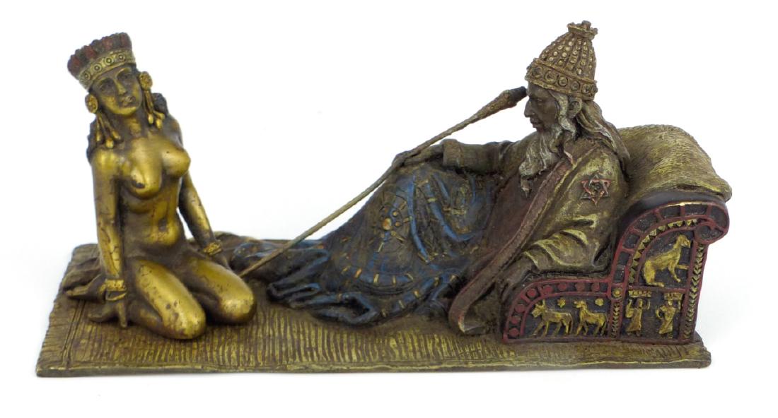 VIENNA BRONZE ARAB & NUDE SLAVE GIRL SCULPTURE: Vienna cold painted bronze sculpture depicting a seated Arab man with nude slave girl on rug. Holds Bergman mark and inscribed Namgreb to underside. Measures 7" (17.8cm) length.