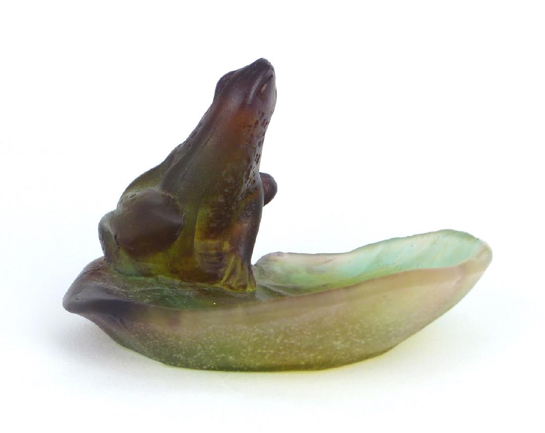 DAUM FRANCE PATE DE VERRE FROG ON LILY PAD: Daum French pate de verre frog on frosted glass lily pad. Signed to side. Measures 4" (10.2cm) width.