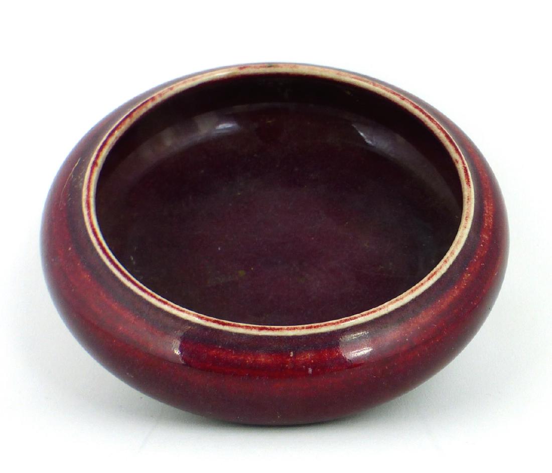 CHINESE SANG DE BOEUF GLAZED PORCELAIN BOWL: Chinese circular and footed Sang de Boeuf oxblood glazed porcelain bowl. Marked to underside. Measures 5 1/4" (13.3cm) diameter.