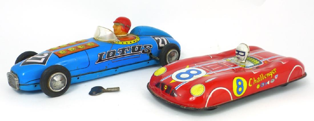 2pc TIN TOY RACE CARS JAPANESE CHALLENGER & LOTUS: 2 tin toy race cars including Japanese Challenger and wind up blue Lotus with key. Challenger marked Japan near trunk. Largest measures 9 1/2" (24cm) length.