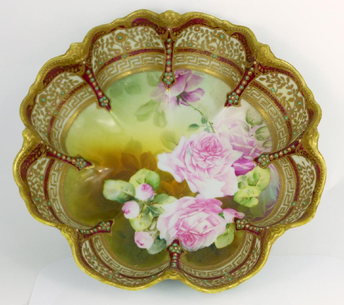 NIPPON JAPANESE ENAMELED & GILT PORCELAIN BOWL: Nippon Japanese porcelain bowl of lobed form having enameled and gilt border with hand painted floral scene to center. Marked to underside. Measures 11 1/4" (28.5cm) width.