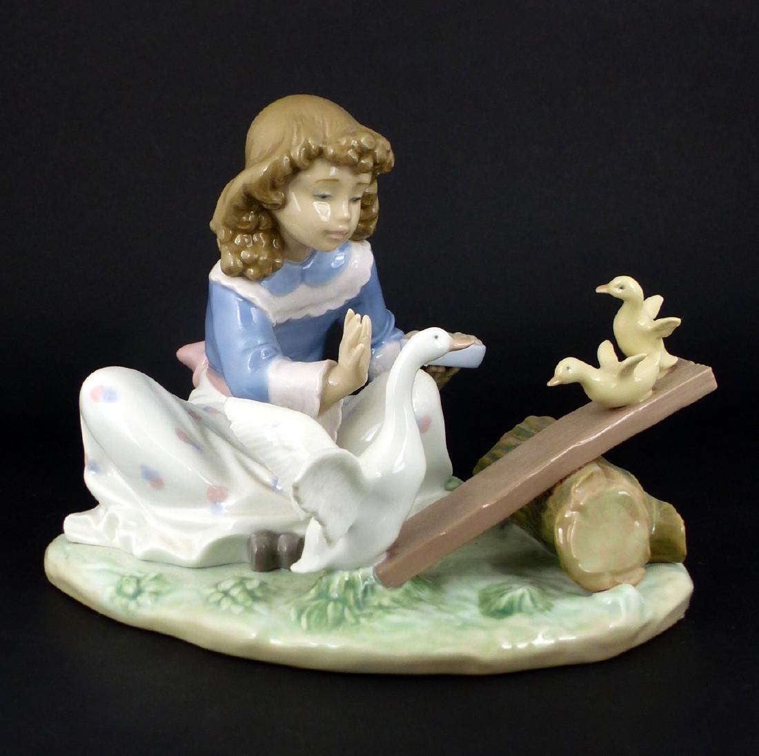 LLADRO 'BARNYWARD SEE SAW' PORCELAIN FIGURINE: Lladro porcelain figure depicting a seated girl feeding geese. Titled 'Barnyard See Saw' #6025. Marked to underside. Measures 8" (20.3cm) length.