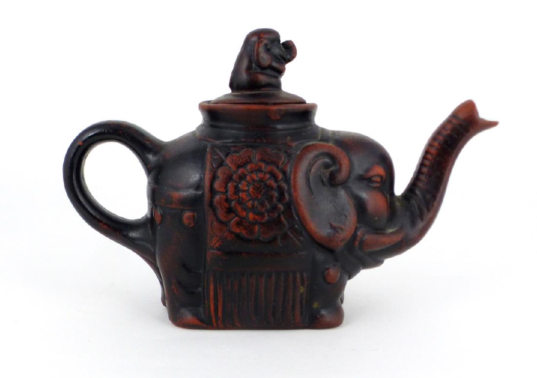 CHINESE YIXING ZISHA ELEPHANT-FORM TEAPOT: Chinese Yixing Zisha clay teapot in the form of an elephant. Marked to underside. Measures 6 1/2" (16.5cm) length.