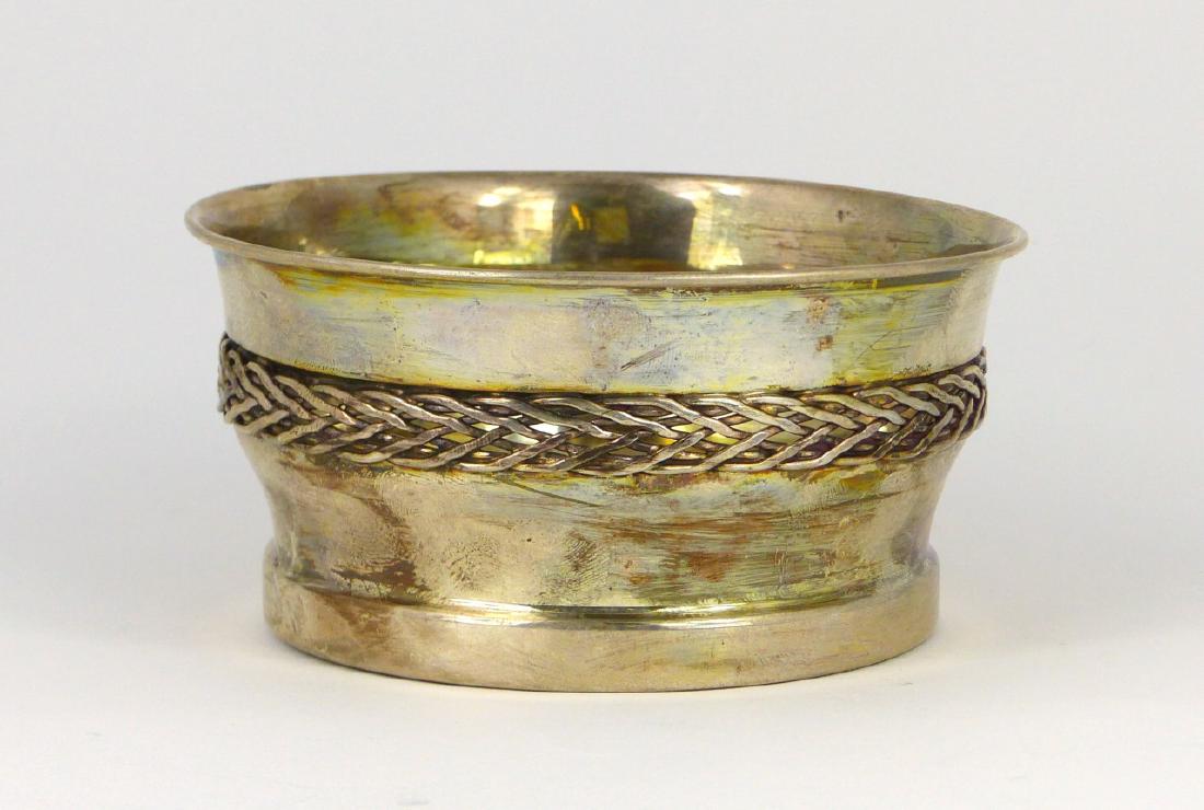 CARTIER STERLING SILVER WINE COASTER: Cartier sterling silver wine coaster with basketweave wirework and lacquered-wood bottom. Marked Cartier, Sterling. Measures 4 3/8" (11cm) diameter. Total weight 4.2ozt (131g).