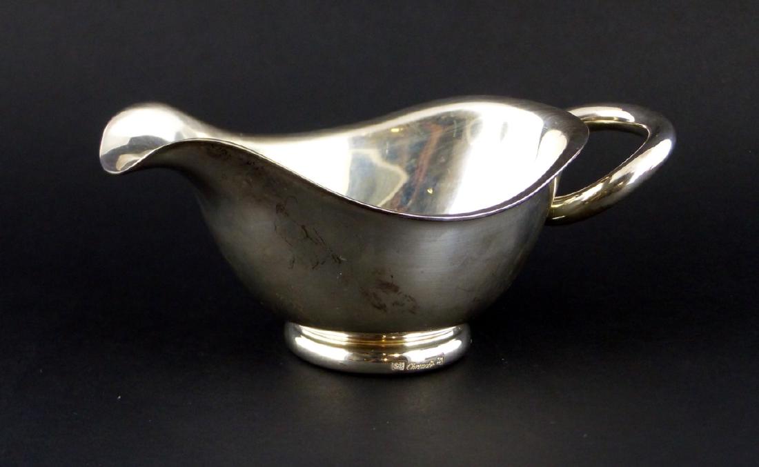 CHRISTOFLE SILVER PLATED 'VERTIGO' GRAVY BOAT: Christofle silverplated gravy boat in the Vertigo pattern. Marked to underside. Measures 6 1/2" (16.5cm) length.