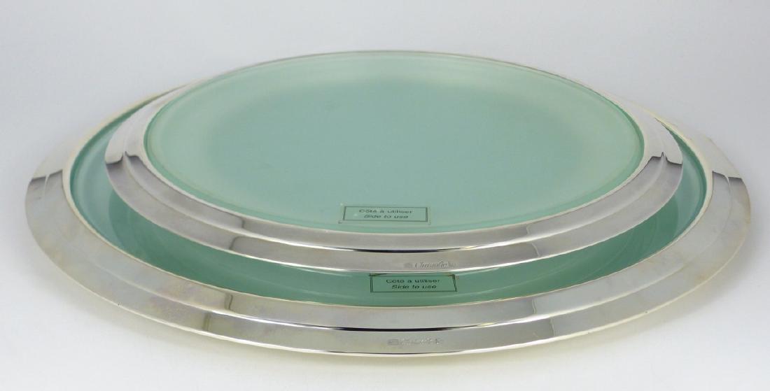 2pc CHRISTOFLE SILVER PLATED & GLASS TRIVETS: 2 Christofle silverplated and glass trivets. Each marked to rim. Largest measures 13 1/2" (34cm) diameter.