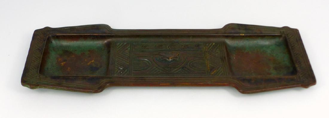 TIFFANY STUDIOS 'AMERICAN INDIAN' BRONZE DESK TRAY: Tiffany Studios bronze pen tray in the 'American Indian' pattern. Marked Tiffany Studios, New York to underside and numbered 1185. Measures 11 1/8" (28.3cm) length.