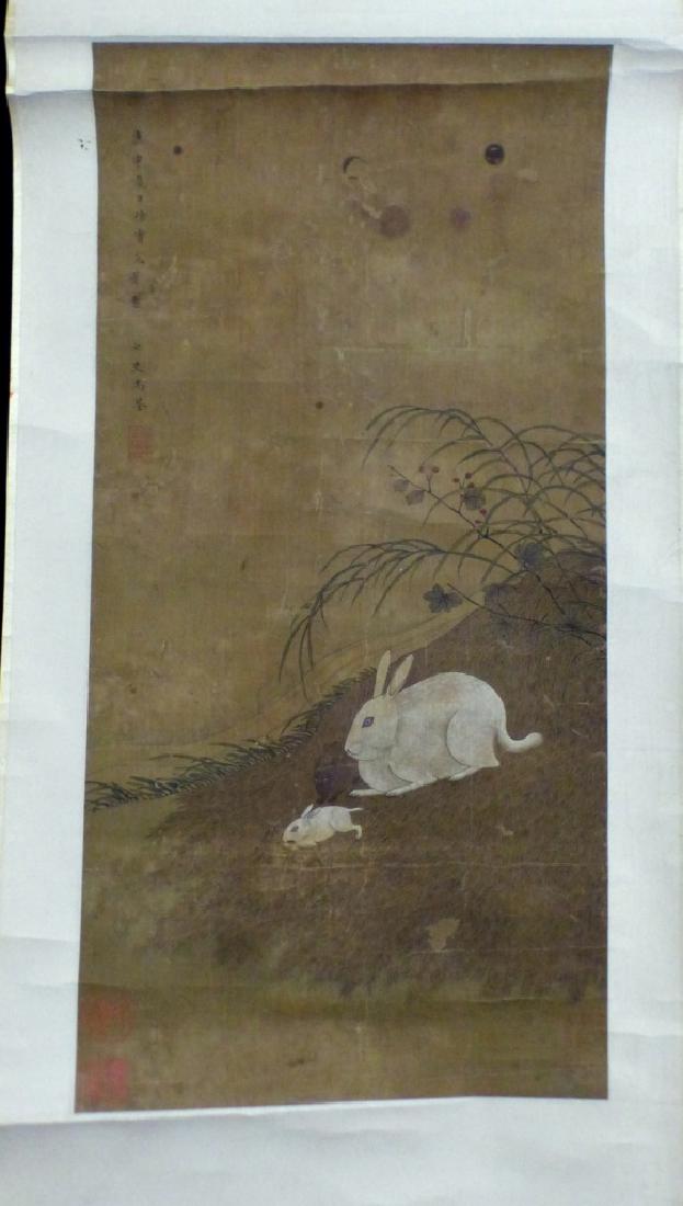 CHINESE SCROLL PAINTING OF RABBITS SIGNED: Chinese scroll painting depicting two rabbits. Holds seals lower left with additional seal and calligraphy upper left. Painting measures 24" (61cm) x 12" (30.5cm) excluding mat. Roller measures 16" (4
