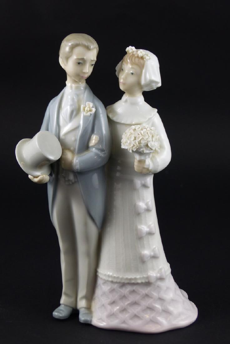 LLADRO PORCELAIN FIGURINE WEDDING COUPLE: Retired Lladro Bride and Groom #4008 (cake topper) porcelain figurine. Marked to underside. Measures 7 3/4" (20cm) height.