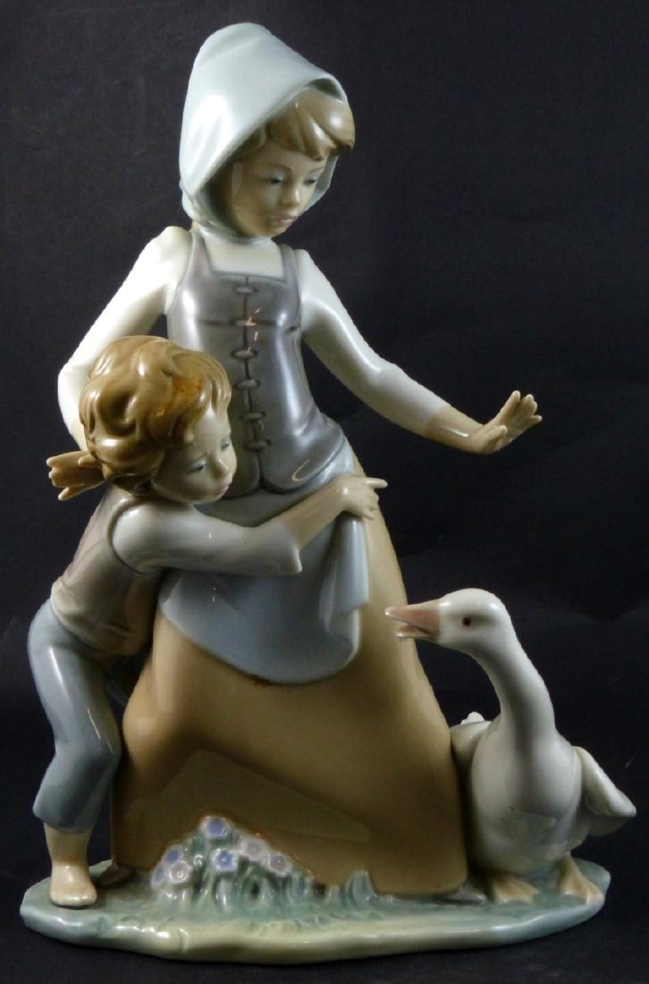LLADRO 'AVOIDING THE GOOSE' PORCELAIN FIGURINE: Lladro 'Avoiding he Goose' porcelain figure #5033. Marked to underside. Measures 10" (25.5cm) height.