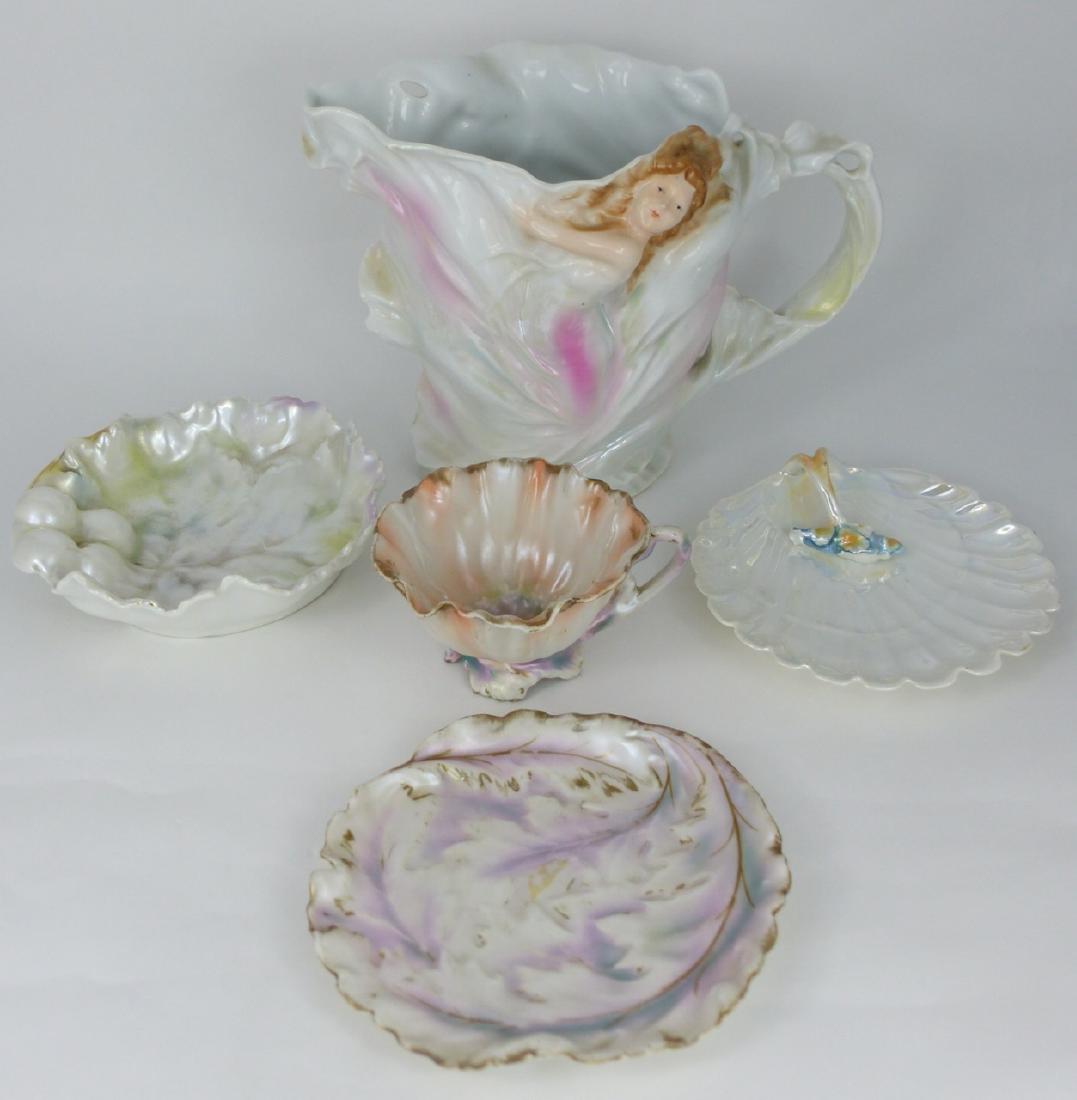 5pc ROYAL BAYREUTH PEARLESCENT PORCELAIN: 5 pieces of Royal Bayreuth pearlescent porcelain table items in various patterns. Includes figural pitcher, poppy teacup, shell dish, grape leaf dish and leaf dish. All piece marked except teacup. Lar
