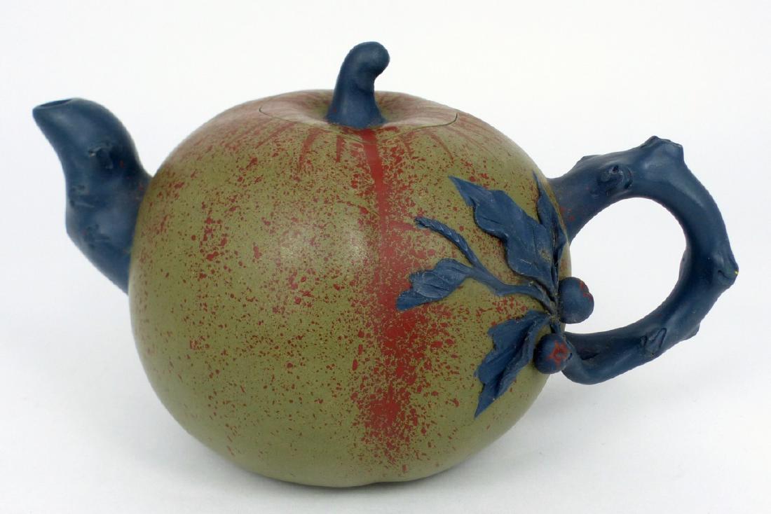 CHINESE YIXING CLAY GOURD-FORM TEAPOT: Chinese Yixing clay polychrome teapot in the form of a gourd. Globular body with handle and spot in the form of a vine. Marked to underside of lid and pot. Measures 6 1/2" (16.5cm) length.