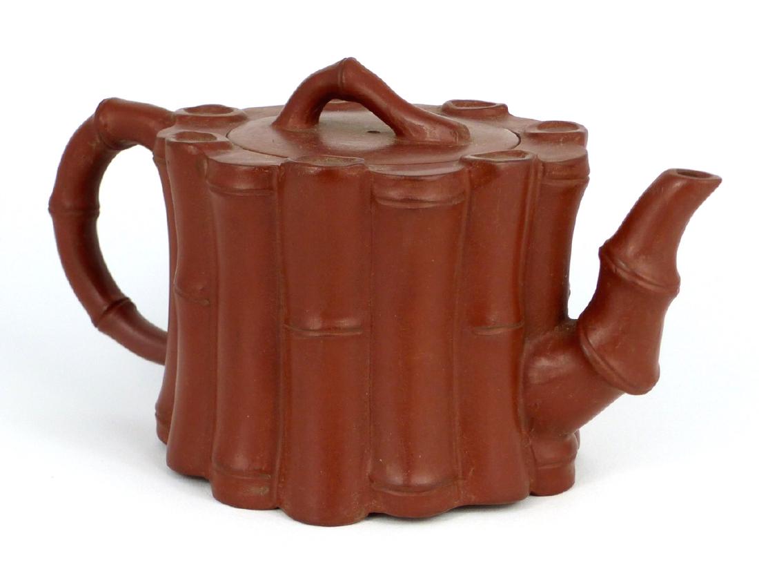 CHINESE YIXING ZISHA BAMBOO-FORM TEAPOT: Chinese Yixing Zisha clay teapot with bamboo motif. Marked to underside. Measures 7" (18cm) length.