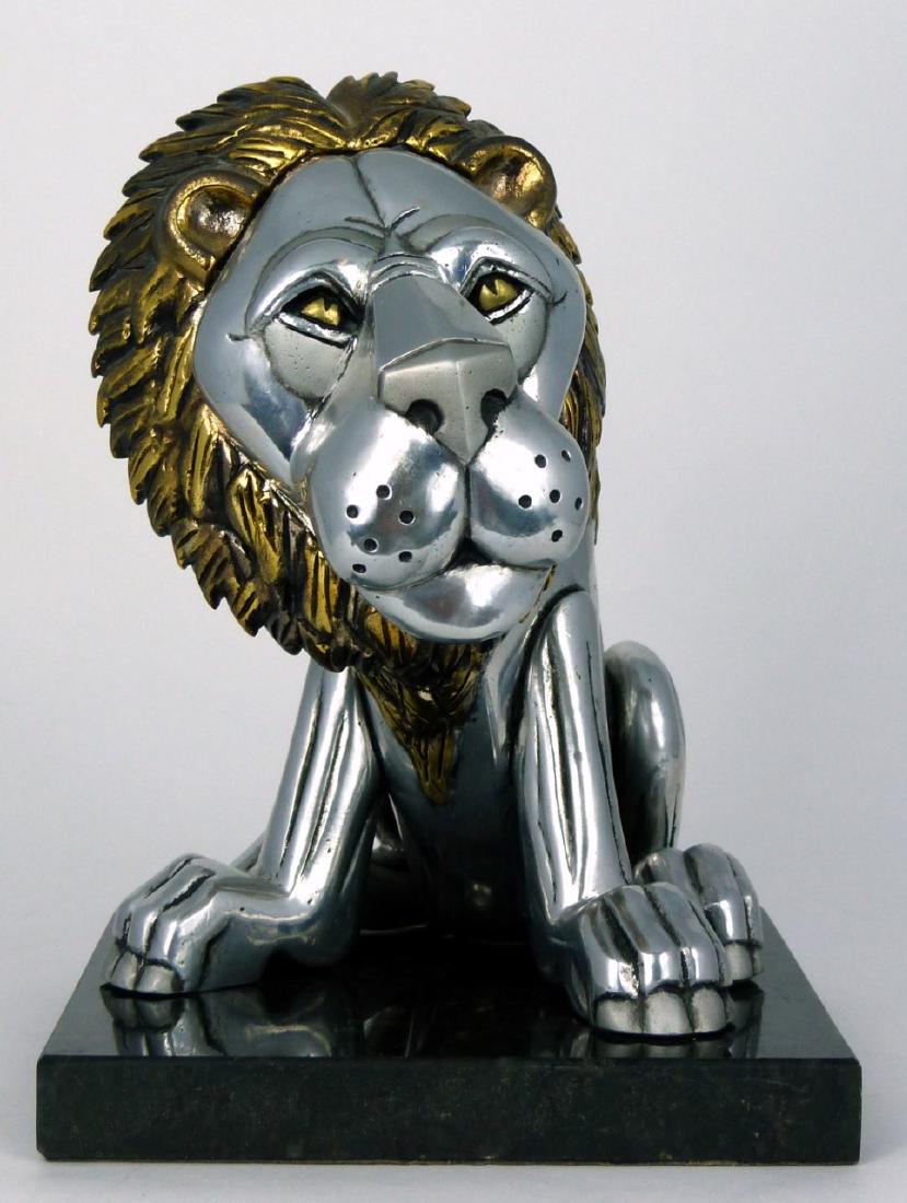 FRANK MEISLER 'SITTING LION' METAL SCULPTURE: Frank Meisler metal sculpture depicting a seated lion with gilded and silver tones on a marble base. Having articulated head and tail. Signed to right leg and numbered 7/730. Measures 7 1/2" (19cm) he