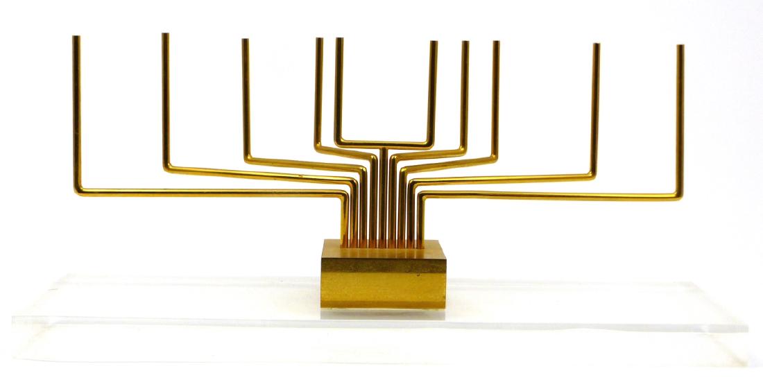 YAACOV AGAM GOLD PLATED KINETIC MENORAH SCULPTURE: Yaacov Agam (Israeli, b. 1928) gold plated kinetic sculpture in the form of a menorah. Signed and numbered 46/47 to base. Includes certificate of authenticity from Nahan Galleries, 1979. Measures 9 7/