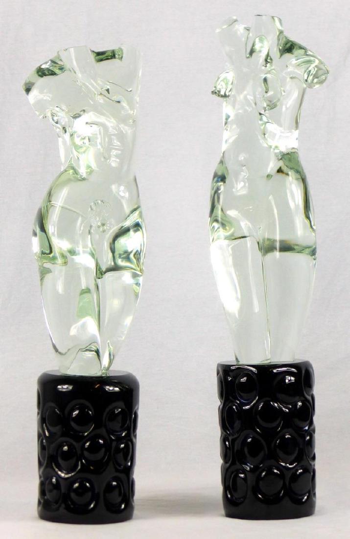 PR MIAN MURANO ART GLASS TORSO SCULPTURES: Pair of Fornace Mian Murano art glass sculptures. Colorless glass nude male and female sculptures, each on a black glass base. Largest measures 25 1/2" (65cm) overall height.