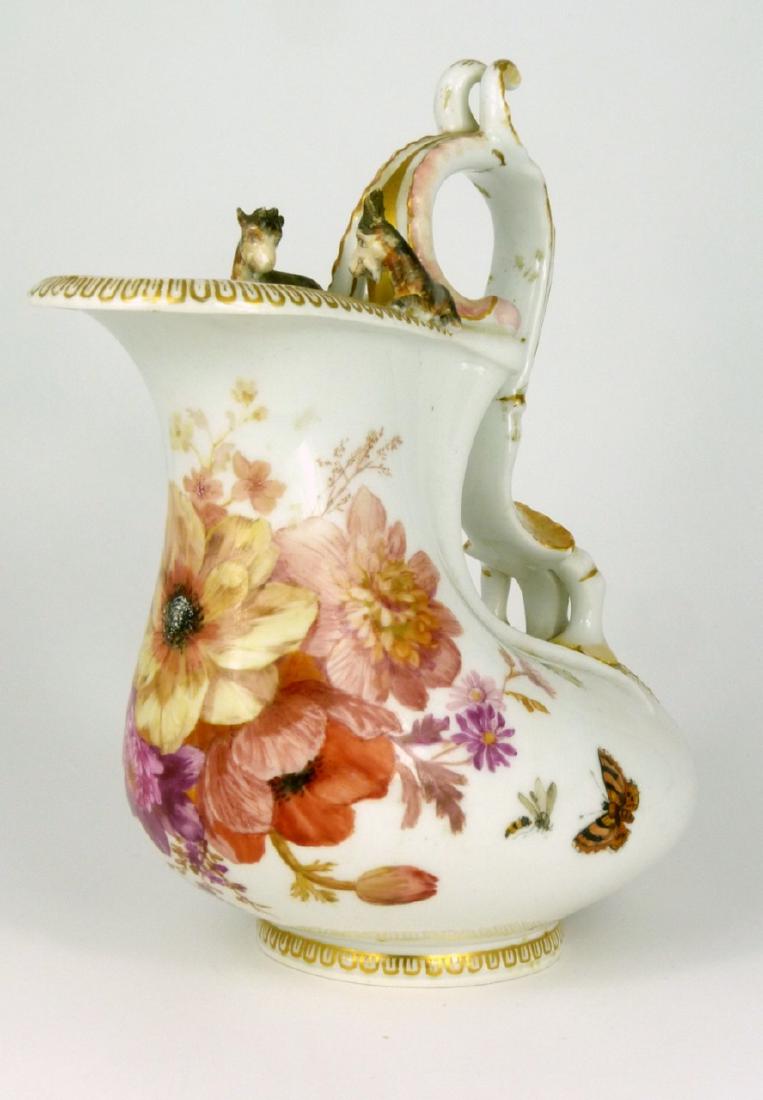 KPM PORCELAIN EWER w RAMS & CHERUB: KPM German porcelain ewer decorated with flowers and insects. Cherub supports scroll handled with a pair of rams seated atop. Holds scepter mark to underside. Measures 9" (23cm) height x 8" (20.3cm) l