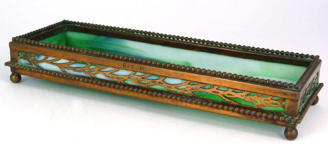 TIFFANY STUDIOS 'GRAPEVINE' BRONZE & GLASS TRAY: Tiffany Studios bronze and glass pen tray in the 'Grapevine' pattern. Marked to underside 'Tiffany Studios, New York'. Measures 8 1/2" (21.5cm) length.
