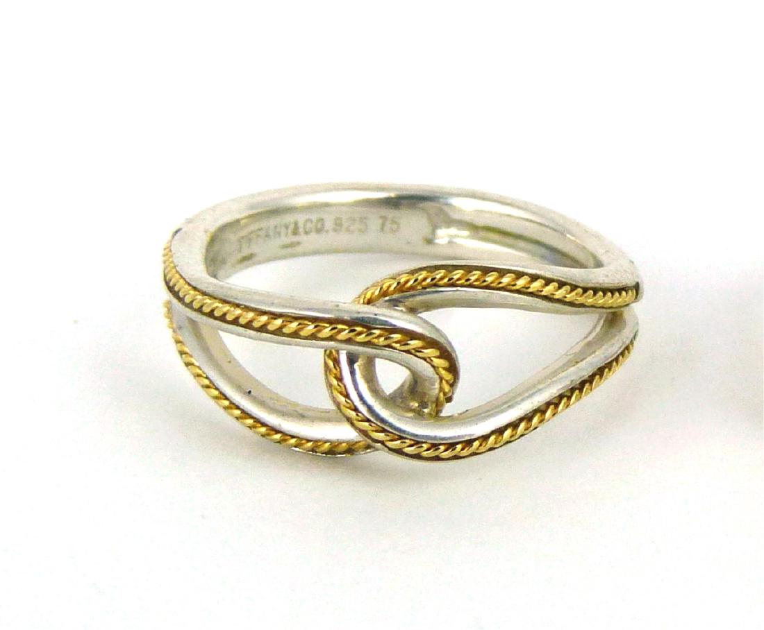 TIFFANY & CO STERLING & 18kt YG 'INFINITY' RING: Tiffany & Company sterling silver 'Infinity' ring with 18kt yellow gold accent. Marked Tiffany & Co, 925, 75. Ring size 6.