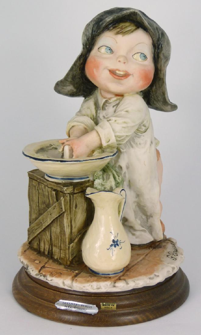 GIUSEPPE ARMANI 'GULLIVER'S WORLD' FIGURINE: Giuseppe Armani figurine depicting a young girl washing up at the sink from the 'Gulliver's World' series. Signed to base. Measures 8 1/2" (21.5cm) height.