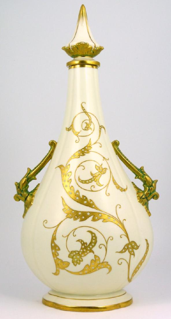ROYAL WORCESTER CHINA WORKS GILT PORCELAIN URN: Royal Worcester China Works ivory porcelain covered vase or urn with gilt handles and accents. Marked to underside or vase and stopper. Measures 14 3/4" (37.5cm) height.