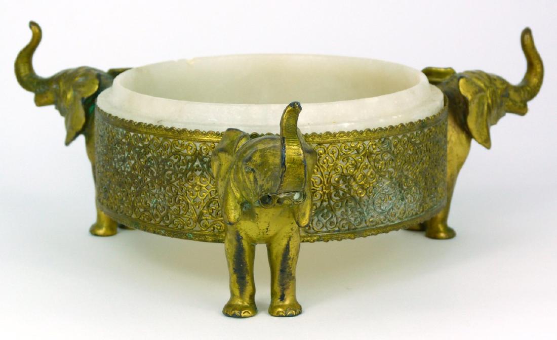 GOLD GILT ELEPHANT BOWL w ALABASTER INSERT: Gilt elephant bowl with pierced design having an alabaster insert. Measures 8 5/8" (22cm) width from trunk to trunk.