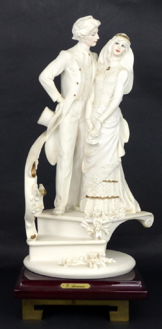 GIUSEPPE ARMANI BRIDE & GROOM SCULPTURE: Giuseppi Armani figural group depicting a bride and groom and spiraling staircase. Signed to backside. Measures 12" height (30.5cm) + 1 3/4" (4.5cm).