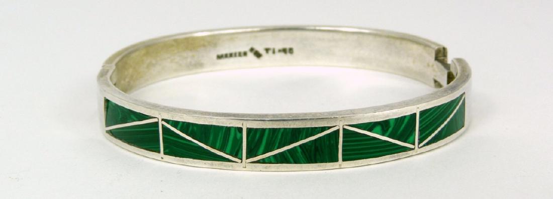 MEXICAN STERLING SILVER MALACHITE BANGLE BRACELET: Mexican sterling silver hinged bangle bracelet with inlaid malachite decoration. Marked Mexico, 925 with maker's hallmark. Measures 2 5/8" (6.5cm) width. Total weight 38.2g.