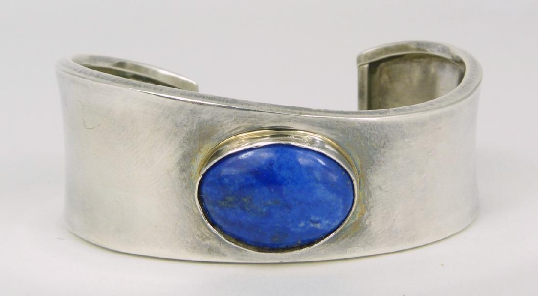 NAVAJO STERLING & LAPIS CUFF BY LESTER CRAIG: Navajo sterling silver and lapis lazuli cuff bracelet. Marked Les Craig, 925 inside paw print. Measures 2 1/2" (6.3cm) width.
