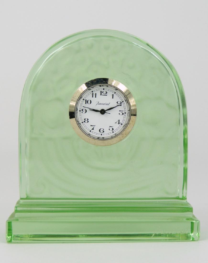 BACCARAT GREEN CRYSTAL DESK CLOCK: Baccarat emerald green frosted crystal desk clock. Depicts a basket overflowing with flowers. Signed to front side of base and marked to underside. Measures 3" (7.6cm) height.