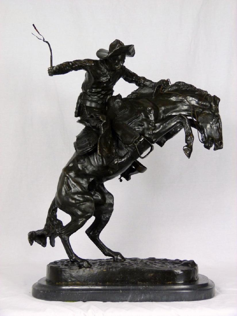 REMINGTON 'BRONCO BUSTER' BRONZE SCULPTURE: 'Bronco Buster' bronze sculpture after Frederic Remington. Signed to bronze base. Measures 18" (45.7cm) width x 22" (55.8cm) height + 1 1/2" (3.7cm) marble base.